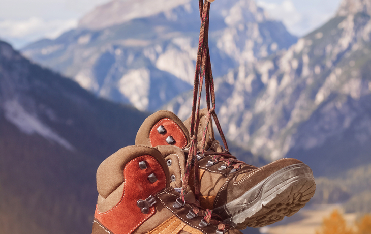 Wanderschuhe in den Bergen hängend